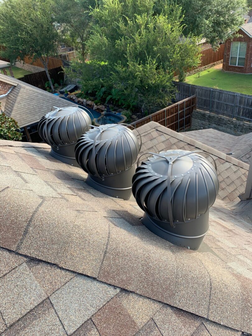 Three different types of vents on a roof.