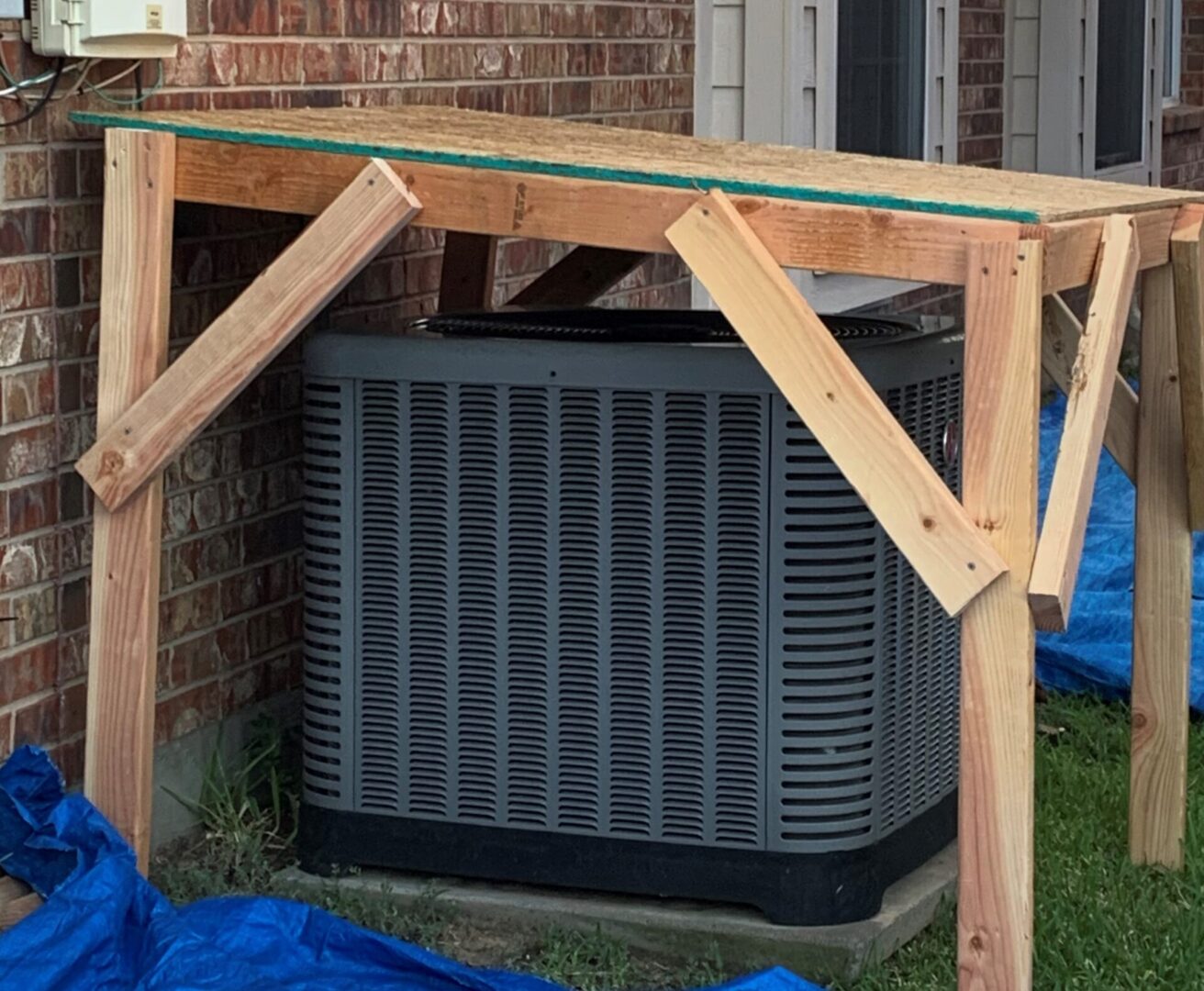 A large air conditioner under construction in the yard.
